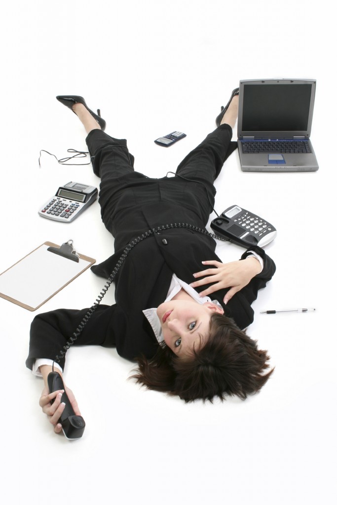 Can't Take Anymore-female business person on the ground surrounded by computer and other gadgets